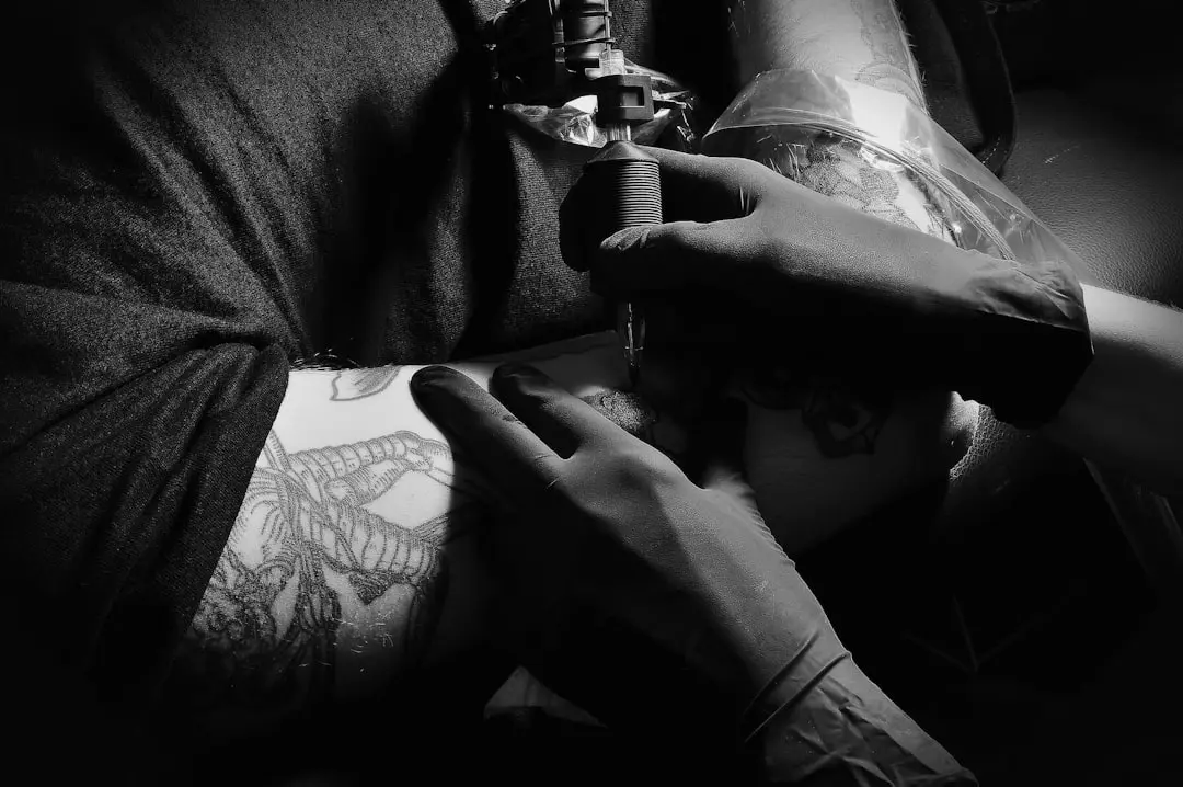 Hero image showing a tattoo artist at work